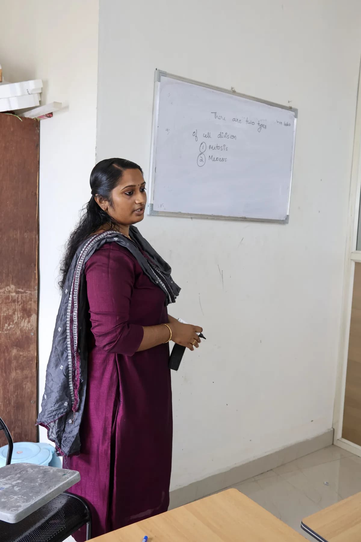 Teacher standing beside a classroom whiteboard